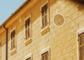 Illustration of Croatian apartment houses with an official registration tag, representing Croatia's 2027 Airbnb rules