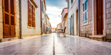 A quiet stone old-town street on a soft autumn morning in coastal Croatia