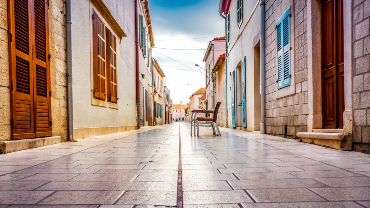 A quiet stone old-town street on a soft autumn morning in coastal Croatia