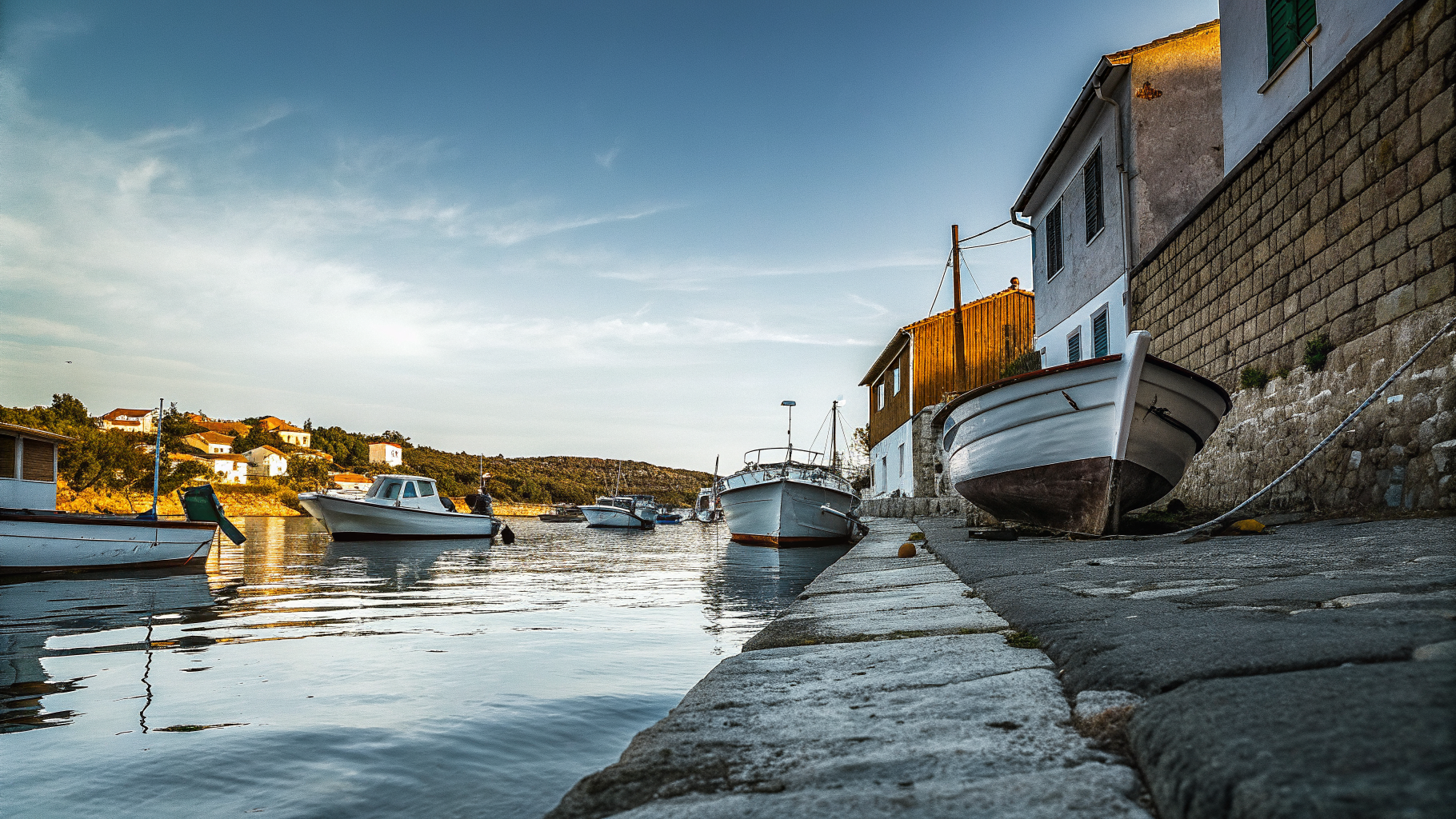 A quiet Dalmatian island harbour town in the off season with moored wooden boats