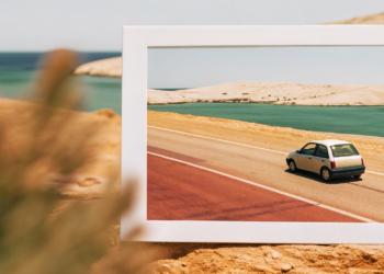 Car driving a winding Adriatic coastal road in Croatia, sea and islands below