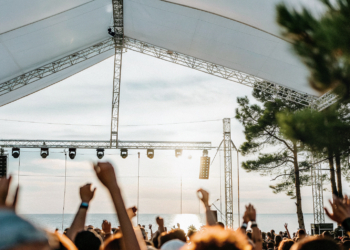 Crowd at an open-air summer music festival on the Croatian coast at dusk