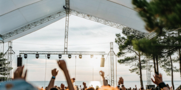Crowd at an open-air summer music festival on the Croatian coast at dusk