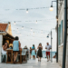 Friends enjoying drinks on an old-town bar terrace at dusk on the Croatian coast