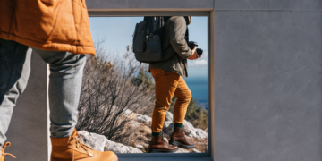 Hikers on a marked limestone trail on the Velebit range while hiking in Croatia, sea visible below