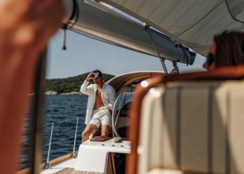 A sailing yacht cruising the calm Adriatic between islands on a clear day in Croatia