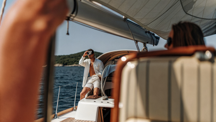 A sailing yacht cruising the calm Adriatic between islands on a clear day in Croatia