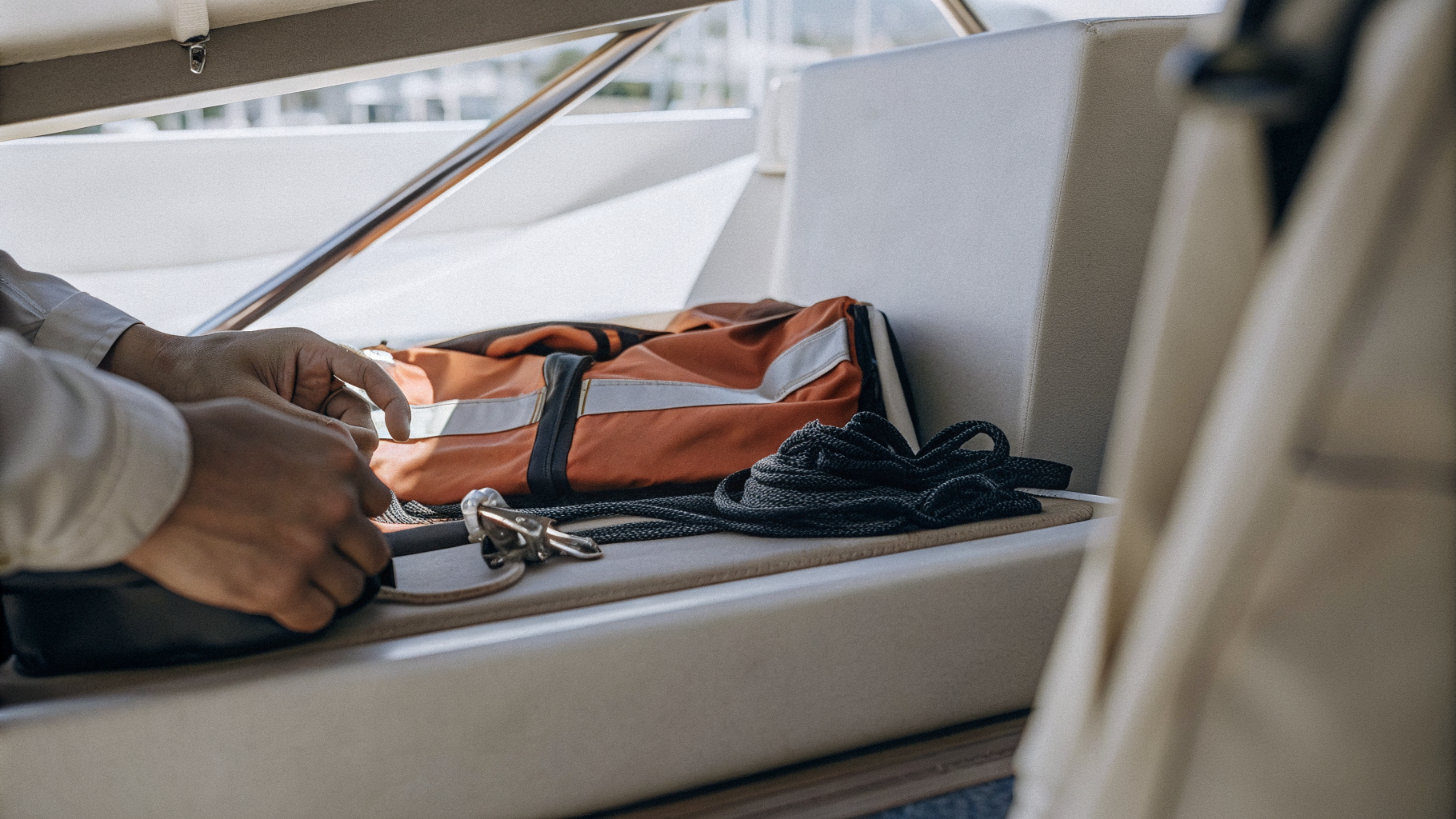 Lifejackets and safety equipment being checked in a yacht cockpit during charter handover
