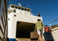 Car ferry loading vehicles beside a passenger catamaran in a Croatian port