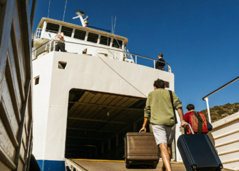 Car ferry loading vehicles beside a passenger catamaran in a Croatian port