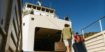 Car ferry loading vehicles beside a passenger catamaran in a Croatian port