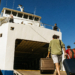 Car ferry loading vehicles beside a passenger catamaran in a Croatian port