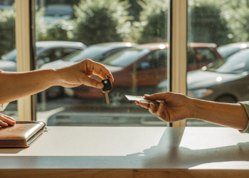 Rental desk handover in Croatia: keys, rental agreement, passport and credit card on the counter